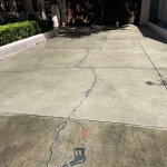 Before and after driveway cleaning in Brandon FL by Peter’s Pressure Washing – dramatic transformation removing black algae, oil stains, and grime from concrete driveway and sidewalk in a Brandon neighborhood home