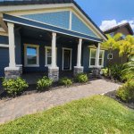 Before and after pressure washing Tampa home exterior with mold and algae removed from vinyl siding using professional soft washing